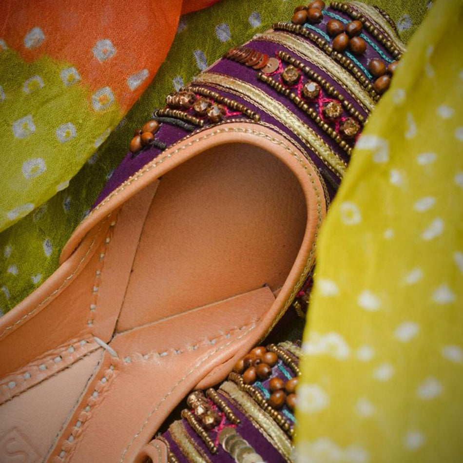 A Breathtaking Pair of Khussa with beads and Stone on a magenta base (Pure Leather)
